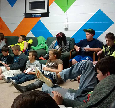 Kids seated in the interior of Crossfire Youth Center